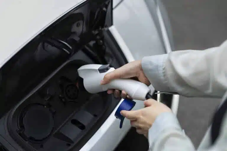 woman charging her electric car station